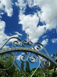 Low angle view of metal against sky