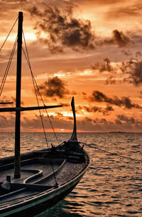 Silhouette boat on sea against sky during sunset
