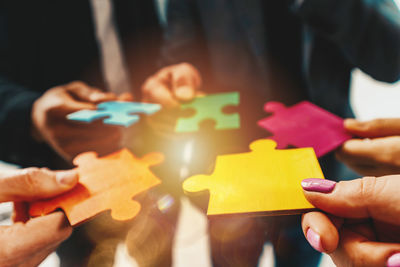 Cropped hand holding jigsaw puzzle