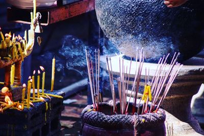 Close-up of smoke emitting from incense in temple