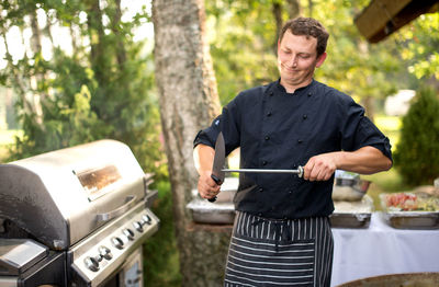 Man standing on barbecue grill