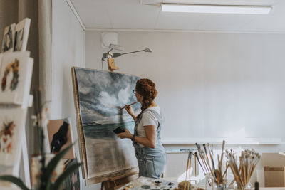 Artist painting in studio