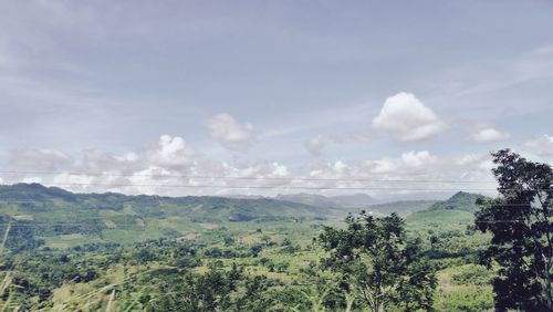 Scenic view of landscape against cloudy sky