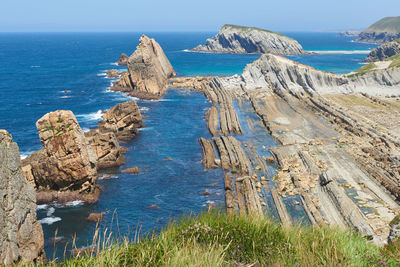 A beautiful view of cliffs surrounded by turquoise blue waters.