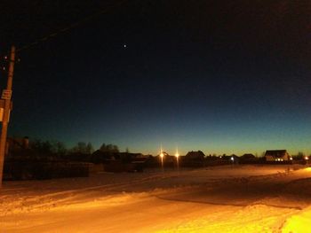 Scenic view of field against clear sky at night