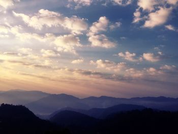 Scenic view of silhouette mountains against sky at sunset