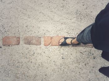 Low section of man standing on footpath