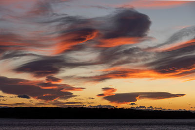 Scenic view of dramatic sky over sea during sunset