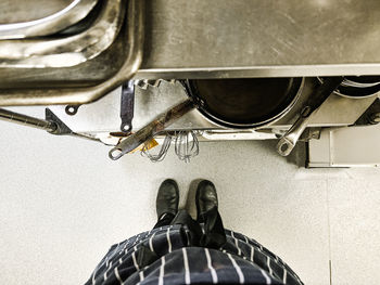 Low section of man standing on escalator