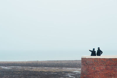 Rear view of couple looking at sea