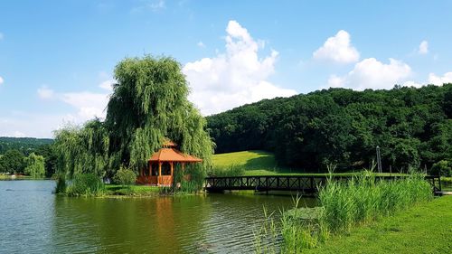 Scenic view of gazebo at lake against sky