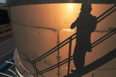 Low section of silhouette man standing on tiled floor