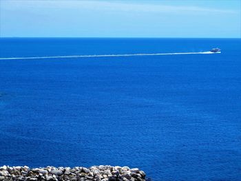 Scenic view of sea against blue sky