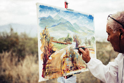 Side view of man holding plastic bag