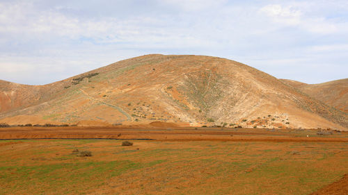 Scenic view of arid landscape against sky