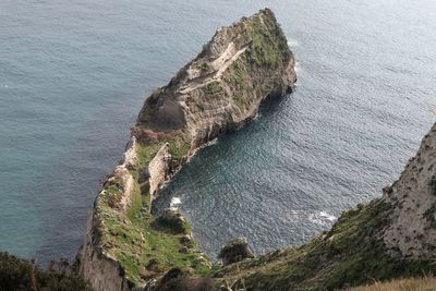 High angle view of rock formations on sea shore