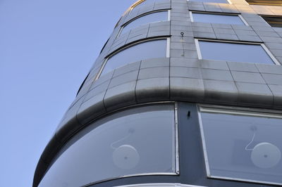Low angle view of modern building against clear blue sky