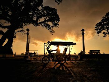 Silhouette bicycle against sky during sunset