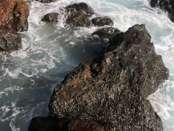 High angle view of rocks in sea