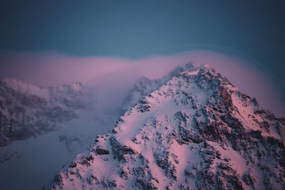 Scenic view of snow covered mountains against sky