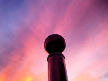 Low angle view of pink balloons against sky during sunset