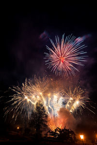 Low angle view of firework display at night