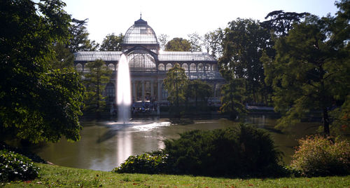 Water fountain in garden against buildings