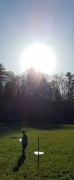 Scenic view of grassy field against sky