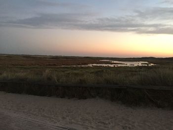 Scenic view of beach against sky during sunset