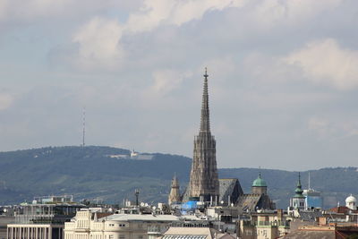 View of town against cloudy sky