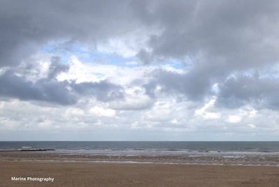 Scenic view of sea against cloudy sky