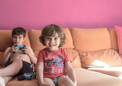 Two little boys having lots of fun with video games.