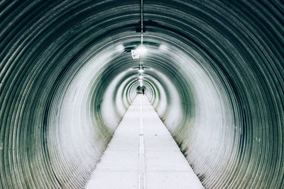 Mid distance of person walking in tunnel