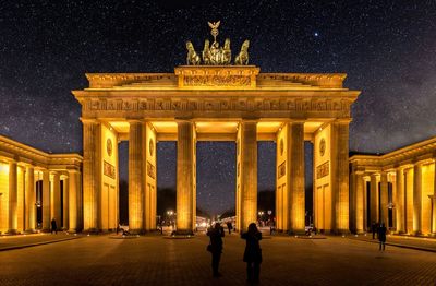 Illuminated brandenburg gate against sky