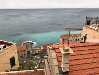 High angle view of buildings by sea against sky
