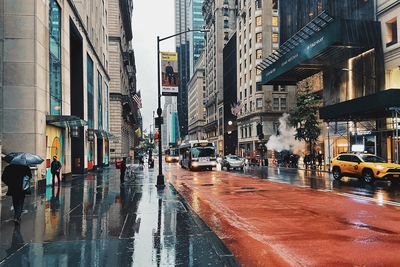 Manhattan street amidst buildings during rainy season