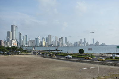 View of cityscape against cloudy sky