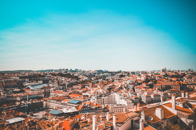 High angle shot of townscape against blue sky