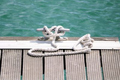Close-up of rope tied on pier