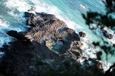 High angle view of rocks in sea