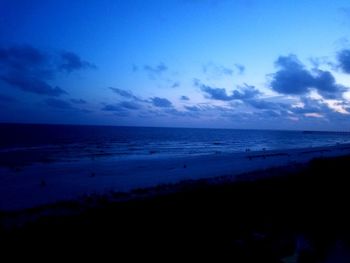 Scenic view of beach against blue sky