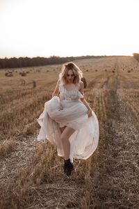 Rear view of woman standing on field