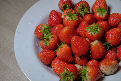 High angle view of strawberries in plate on table