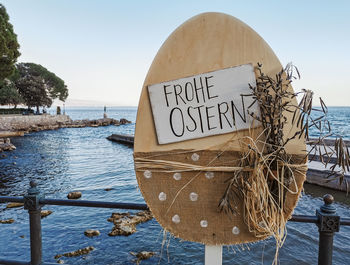 Close-up of text on beach against clear sky