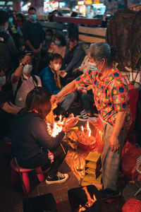 Group of people at market stall