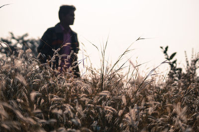 Man on field against sky