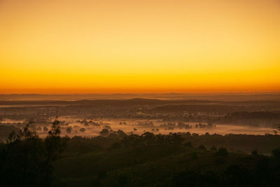 High angle view of landscape against orange sky