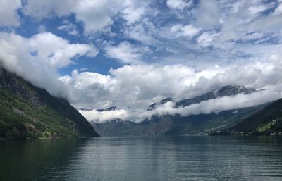 Scenic view of lake and mountains against sky