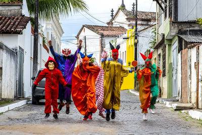 Group of people wearing carnival mask