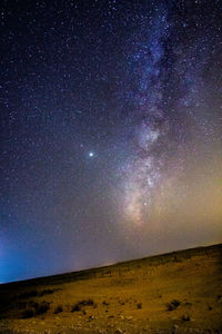 Scenic view of landscape against sky at night